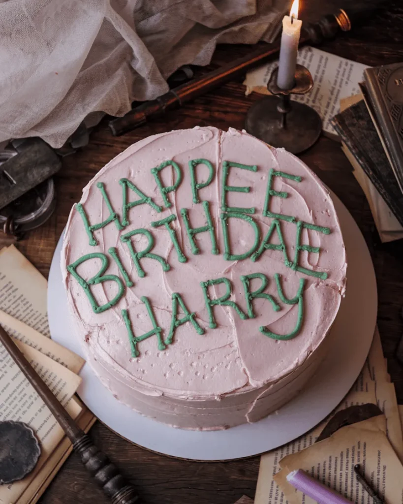 Harry Potter Birthday Cake with pink frosting and green icing letters